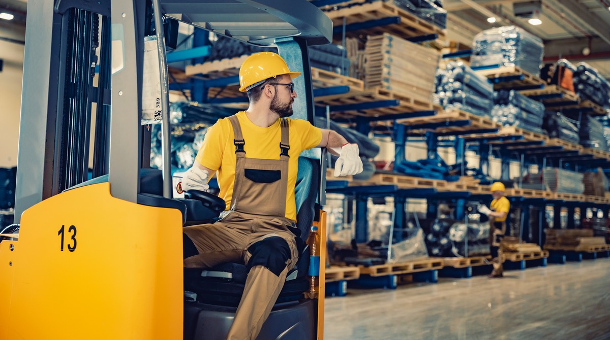 Warehouse operator completing a digital forklift inspection checklist on a tablet