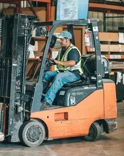 Forklift dealer technician running a digital fleet study on a tablet